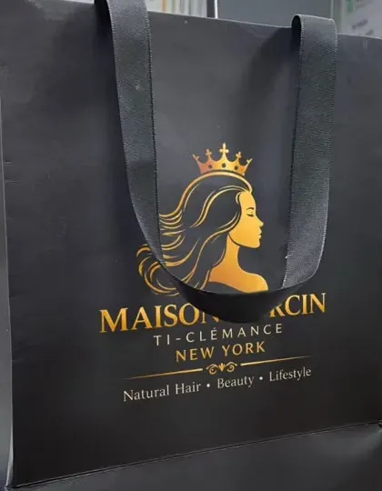 Matte black Maison Dorcin shopping bag with gold foil logo